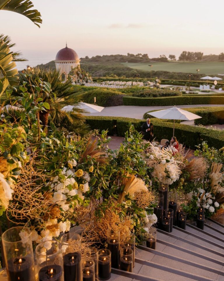 Candlelit terrace steps toward the Rotunda at sunset, Pelican Hill, Revelry Event Designers