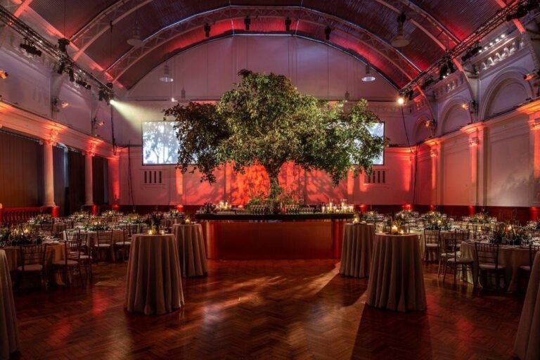 Lindley Hall set for a dinner under warm lighting, The Royal Horticultural Halls, Royal Horticultural Halls, lindley hall dinner lit