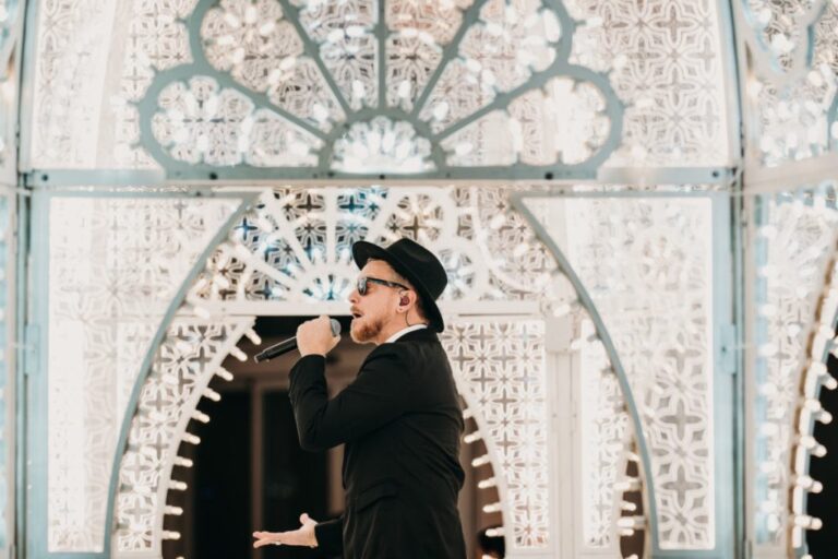 Male vocalist framed by the white illuminated arch, Rinaldi Production