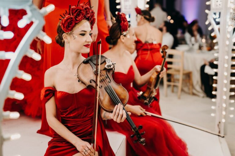 Violinists in red velvet dresses with floral headpieces, Rinaldi Production