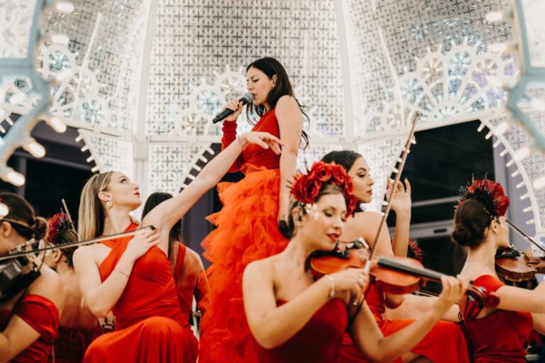 Lead vocalist in red with a string ensemble, Rinaldi Production
