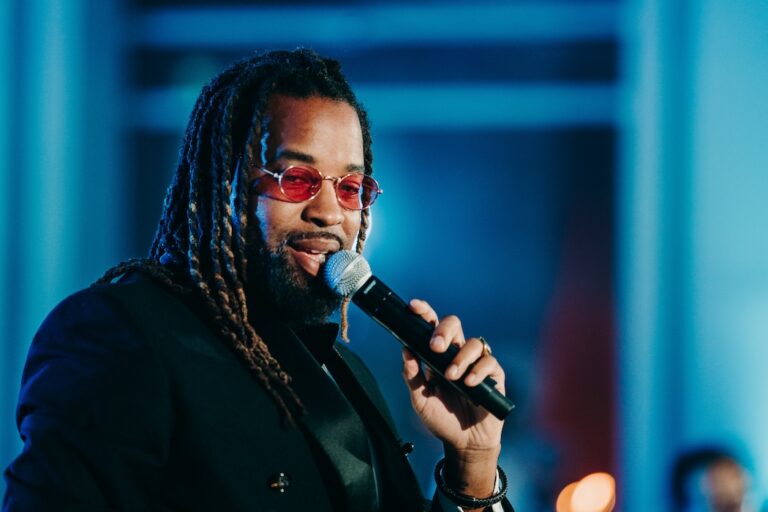 Male vocalist performing under blue stage lighting, Rinaldi Production
