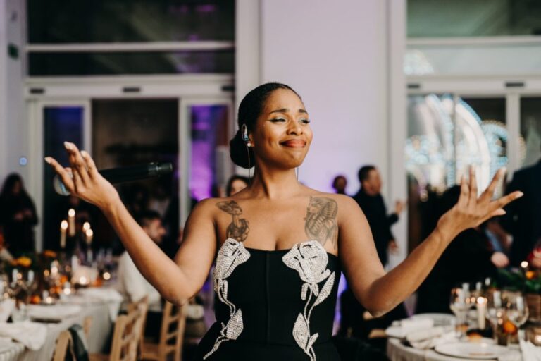 Vocalist performing among candlelit dinner tables, Rinaldi Production