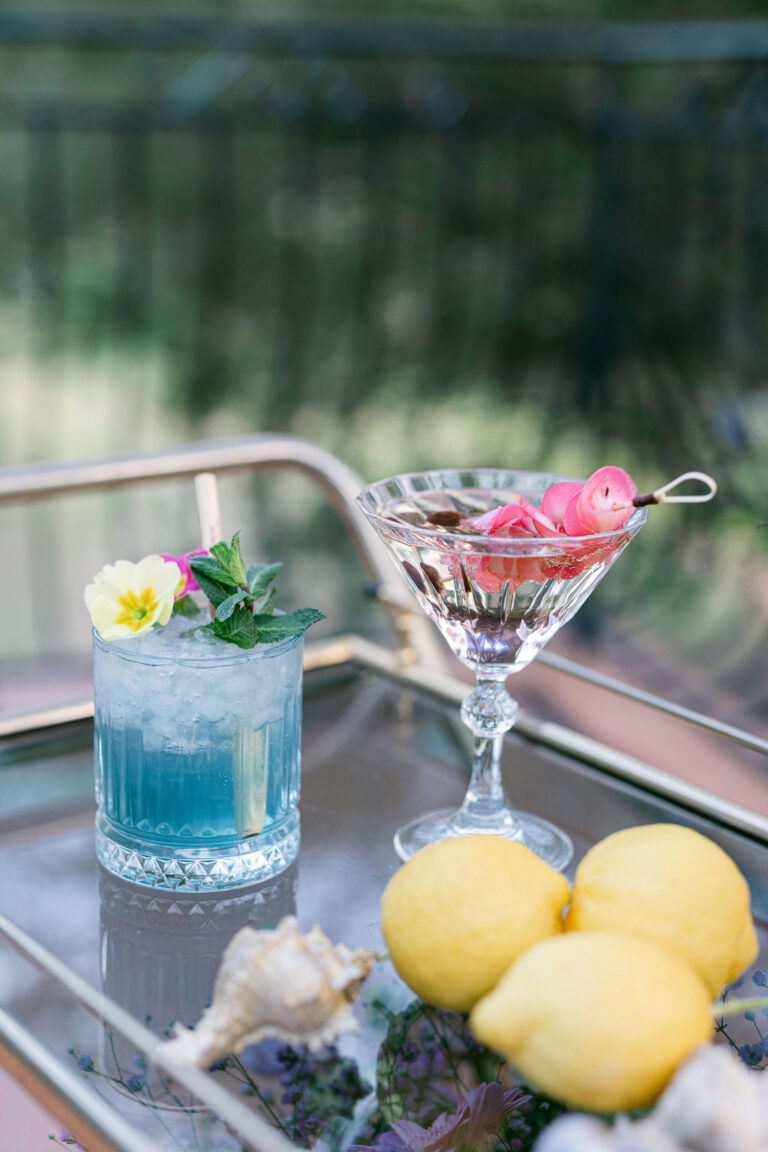 A cocktail garnished with lemon and flowers, Rocabella