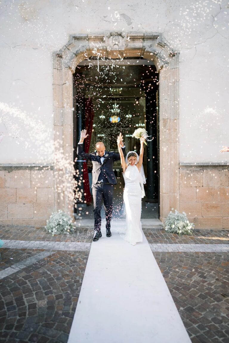 Emily and Giuseppe leaving the church in a burst of confetti, Calabria, Rocco Daniele Photography
