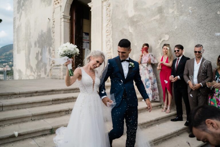 Kamila and Federico coming down the church steps among their guests, San Lucido, Calabria, Rocco Daniele Photography