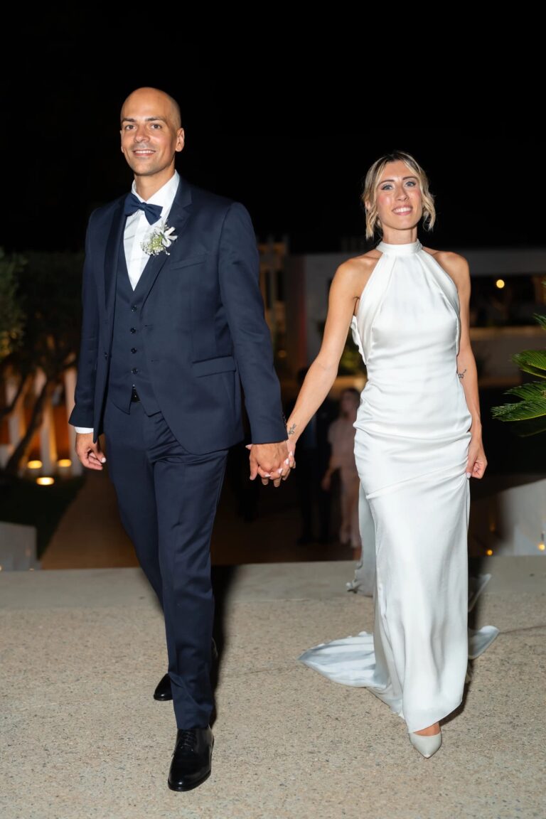 Emily and Giuseppe walking hand in hand into the evening of their Tenuta Klopè wedding, Calabria, Rocco Daniele Photography