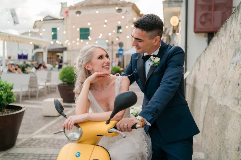 The couple with a yellow scooter in a lit street, San Lucido, Rocco Daniele Photography
