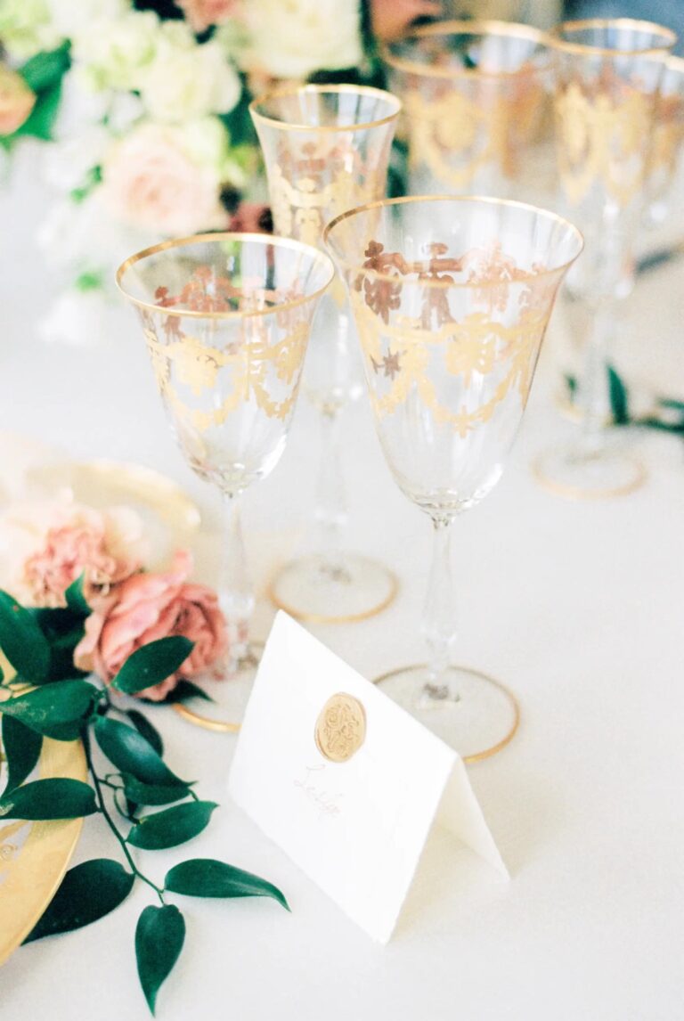 Gold-patterned glasses, roses and a sealed place card on the table, Torre di Pila, Rocco Daniele Photography