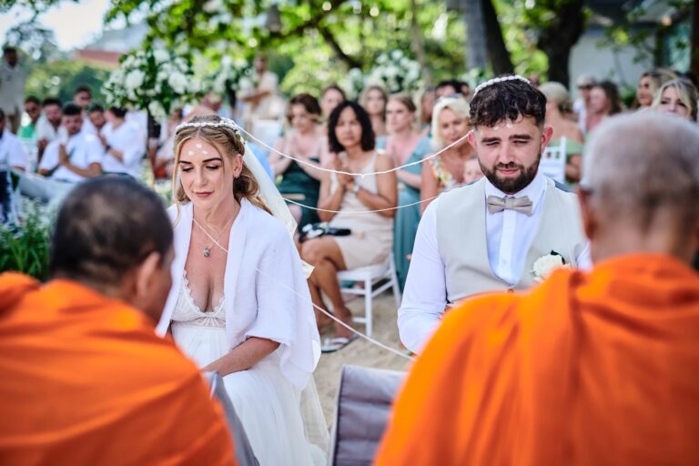 A Thai Buddhist wedding ceremony on the beach with monks and guests, Rocky’s Boutique Resort