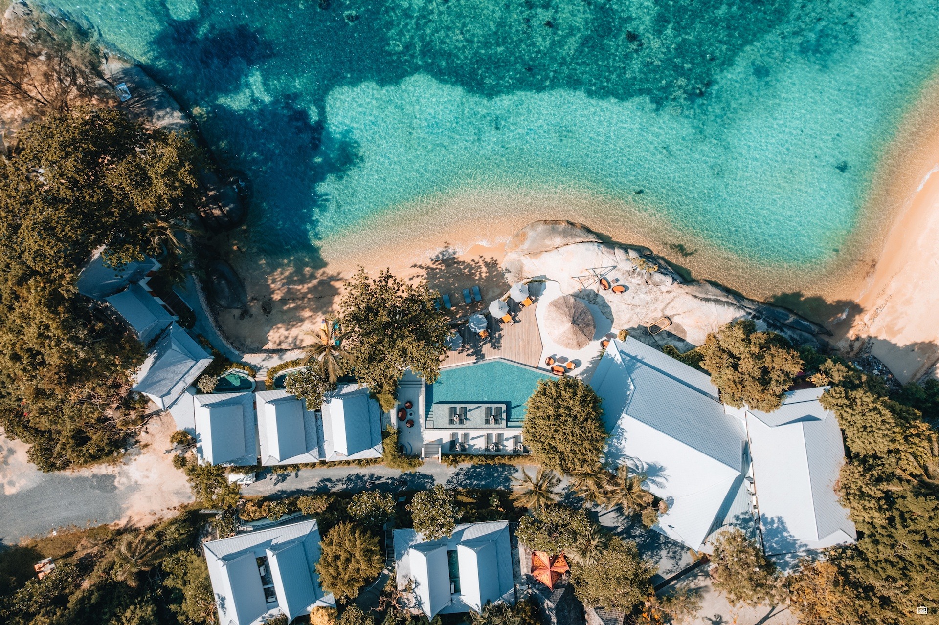 Aerial view of the resort buildings, pool and cove on the Lamai coast of Koh Samui, Rocky’s Boutique Resort