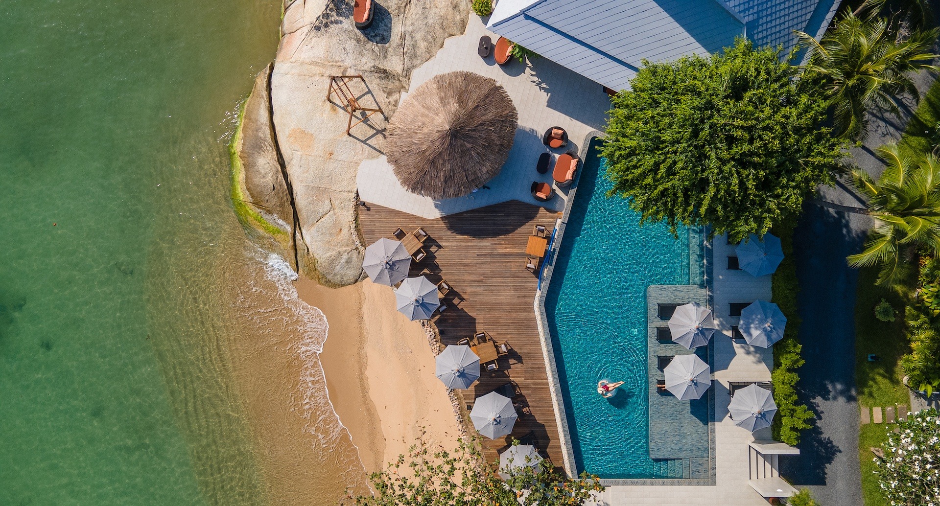 Aerial view of the beachfront pool, sun deck and granite rocks at the water's edge, Rocky’s Boutique Resort