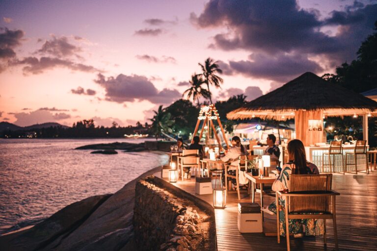 The restaurant terrace on the rocks above the water at dusk, Rocky’s Boutique Resort