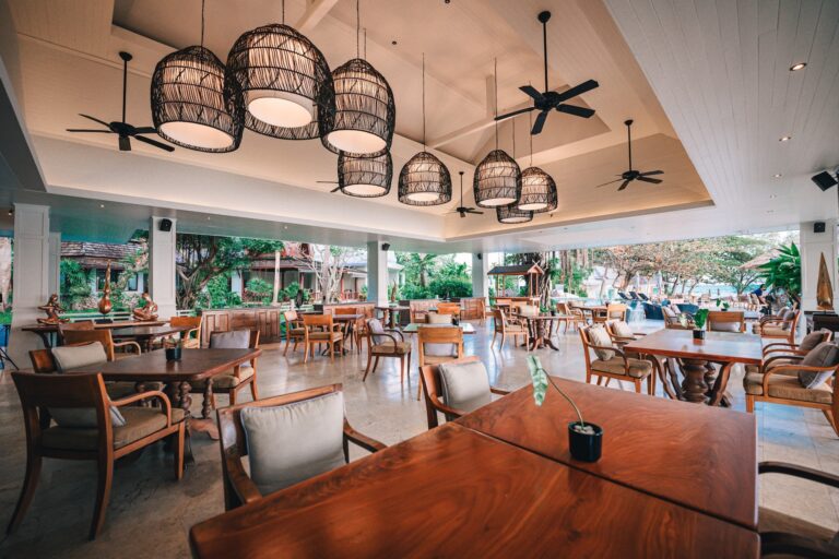 The Dining Room interior with its woven pendant lights and timber tables, Rocky’s Boutique Resort