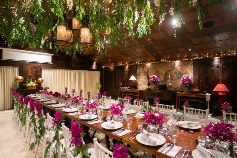 Long banquet table dressed with pink flowers in the private banquet room, Rocky’s Boutique Resort