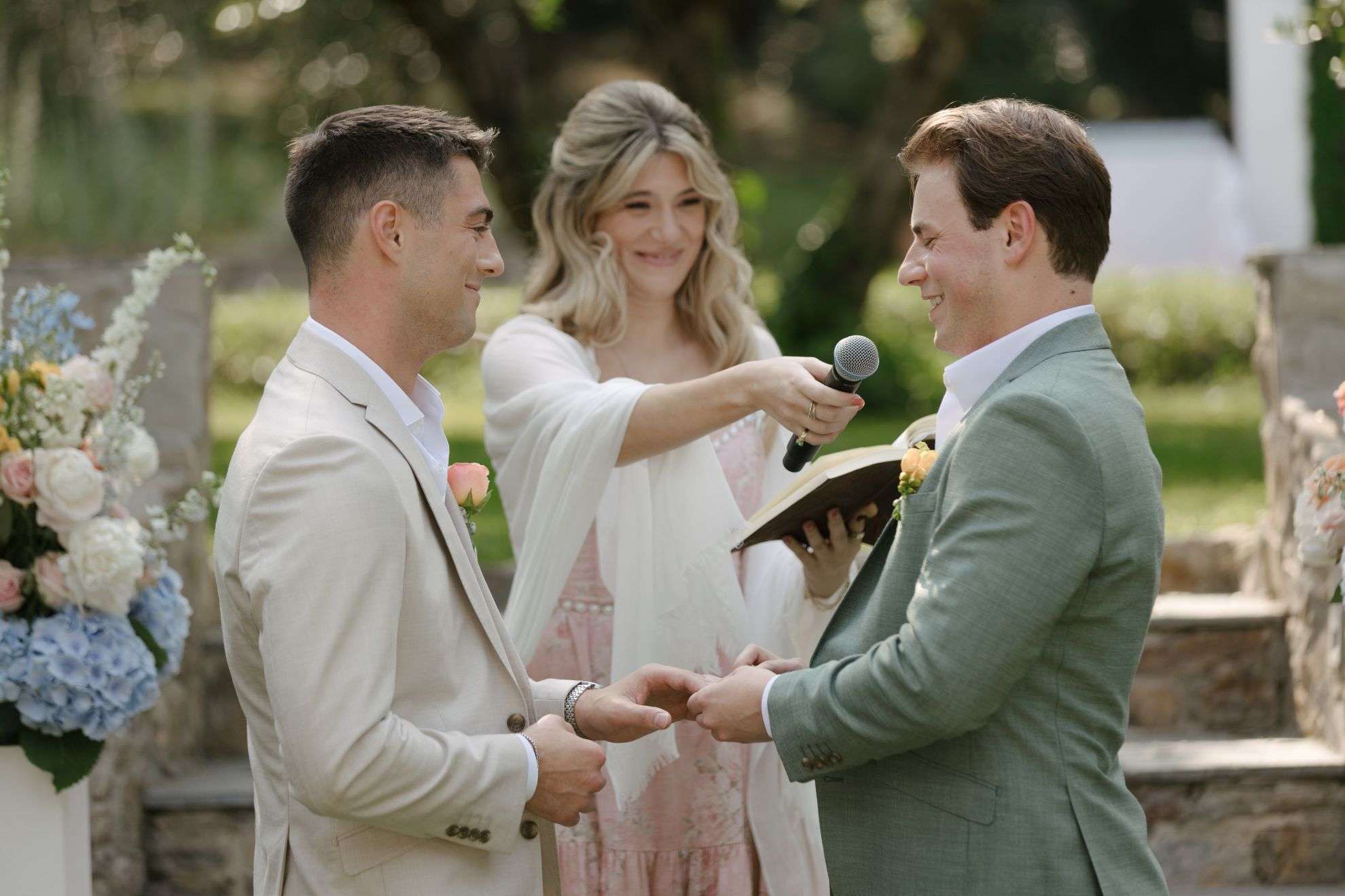 Vows read in a garden ceremony, hydrangeas behind (Chris & Ben), RoRas Destination Wedding