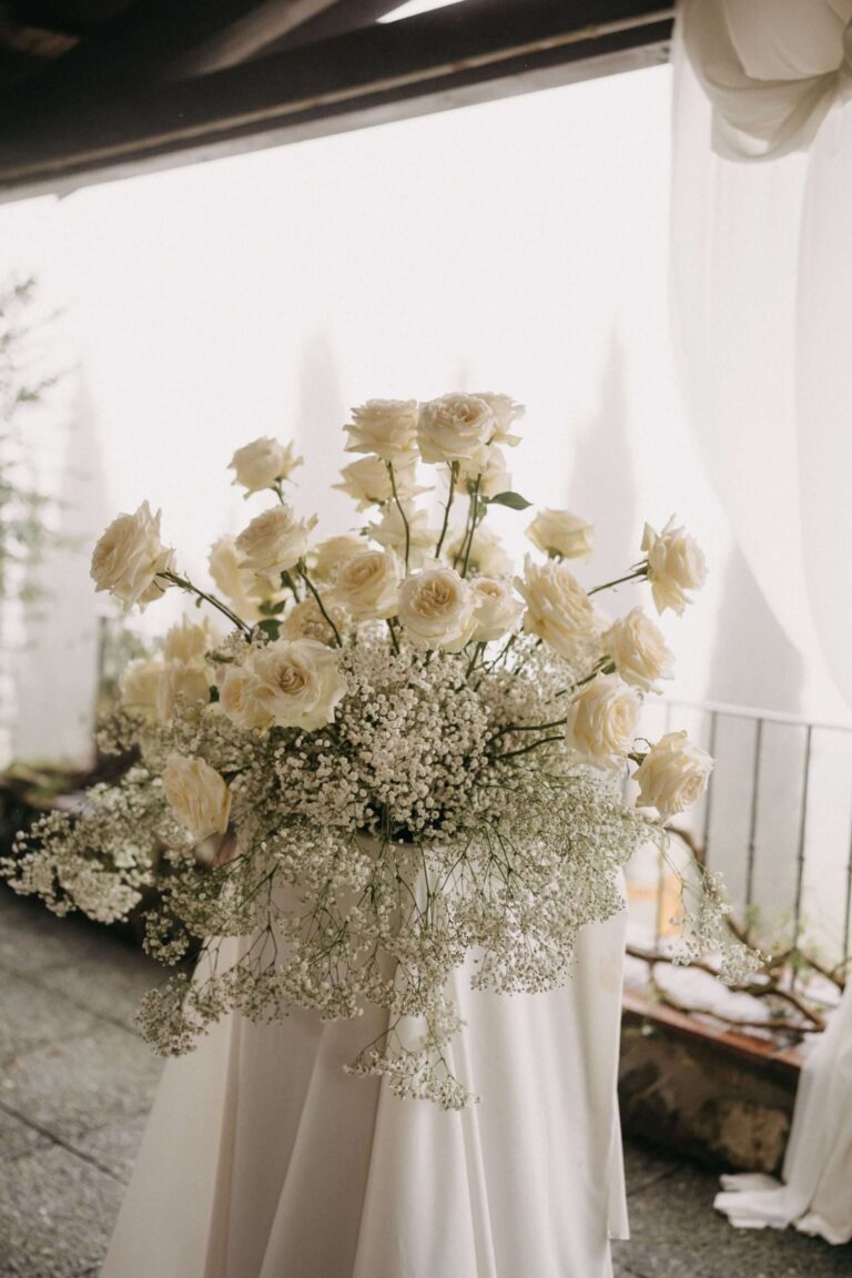 White roses and gypsophila arranged at the ceremony space (Em & Callum), RoRas Destination Wedding