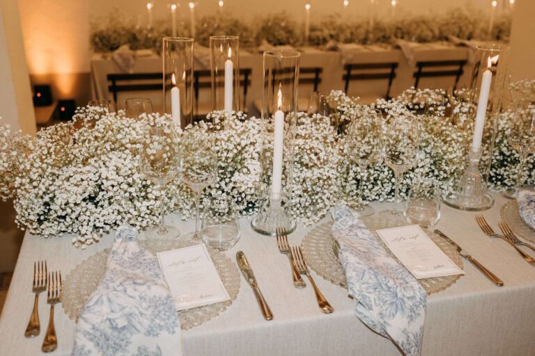 Long table dressed with gypsophila, white tapers and blue toile napkins (Em & Callum; venue not named on the site), RoRas Destination Wedding