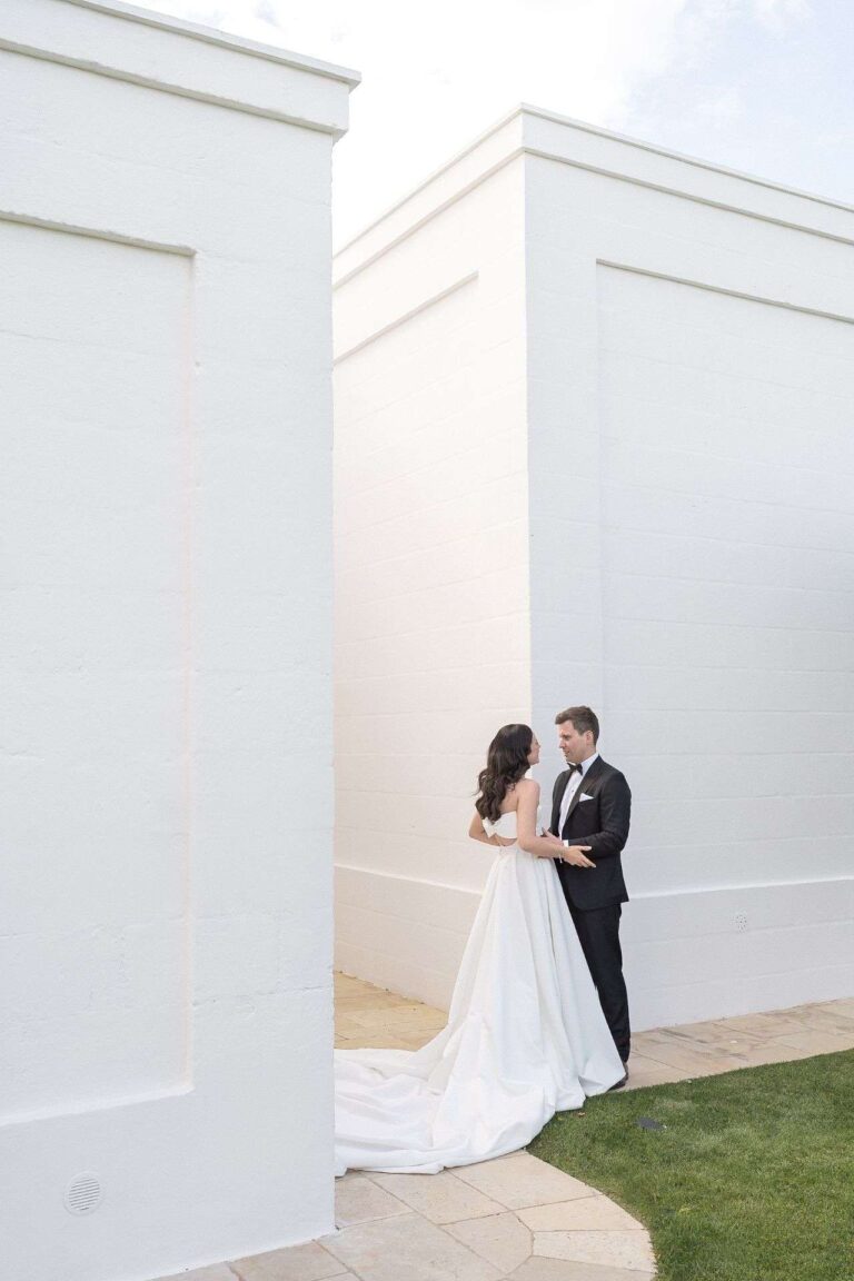 The couple between whitewashed walls (Jane & Mark; venue not named on the site), RoRas Destination Wedding