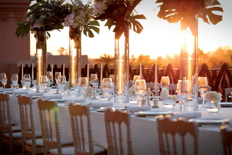 Dinner table set at sunset with floral centrepieces, Royal Mansour Marrakech
