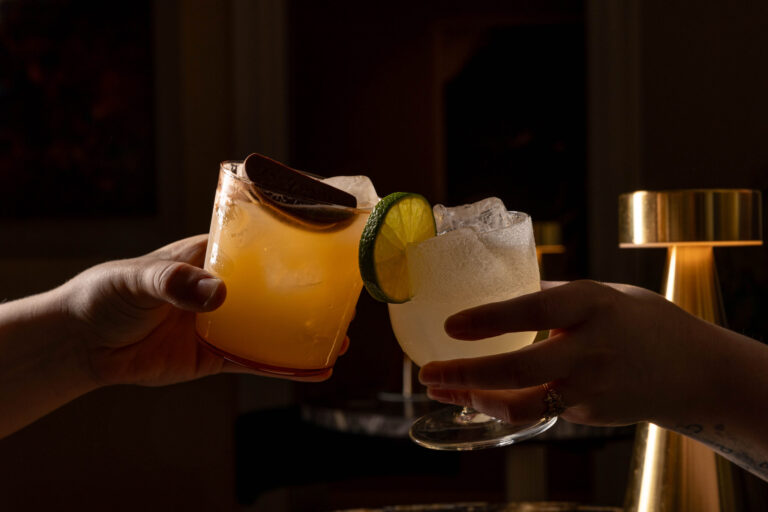 Two cocktails raised in a toast, RSA House