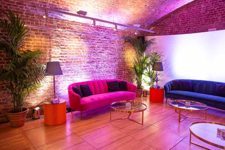 A lounge corner with bright sofas in the Vaults, RSA House