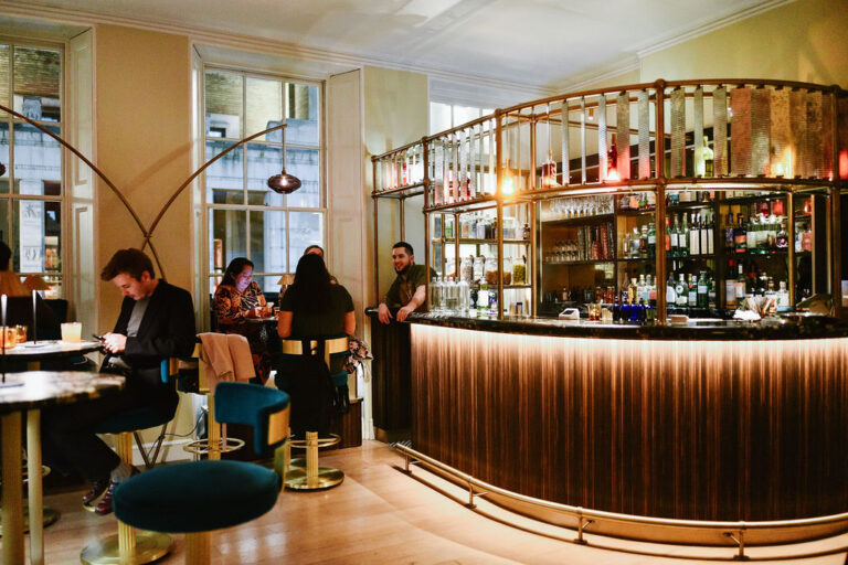 A cocktail bar with a curved bar front, RSA House