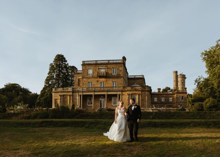 A couple on the lawn in front of the manor house, Salomons Estate