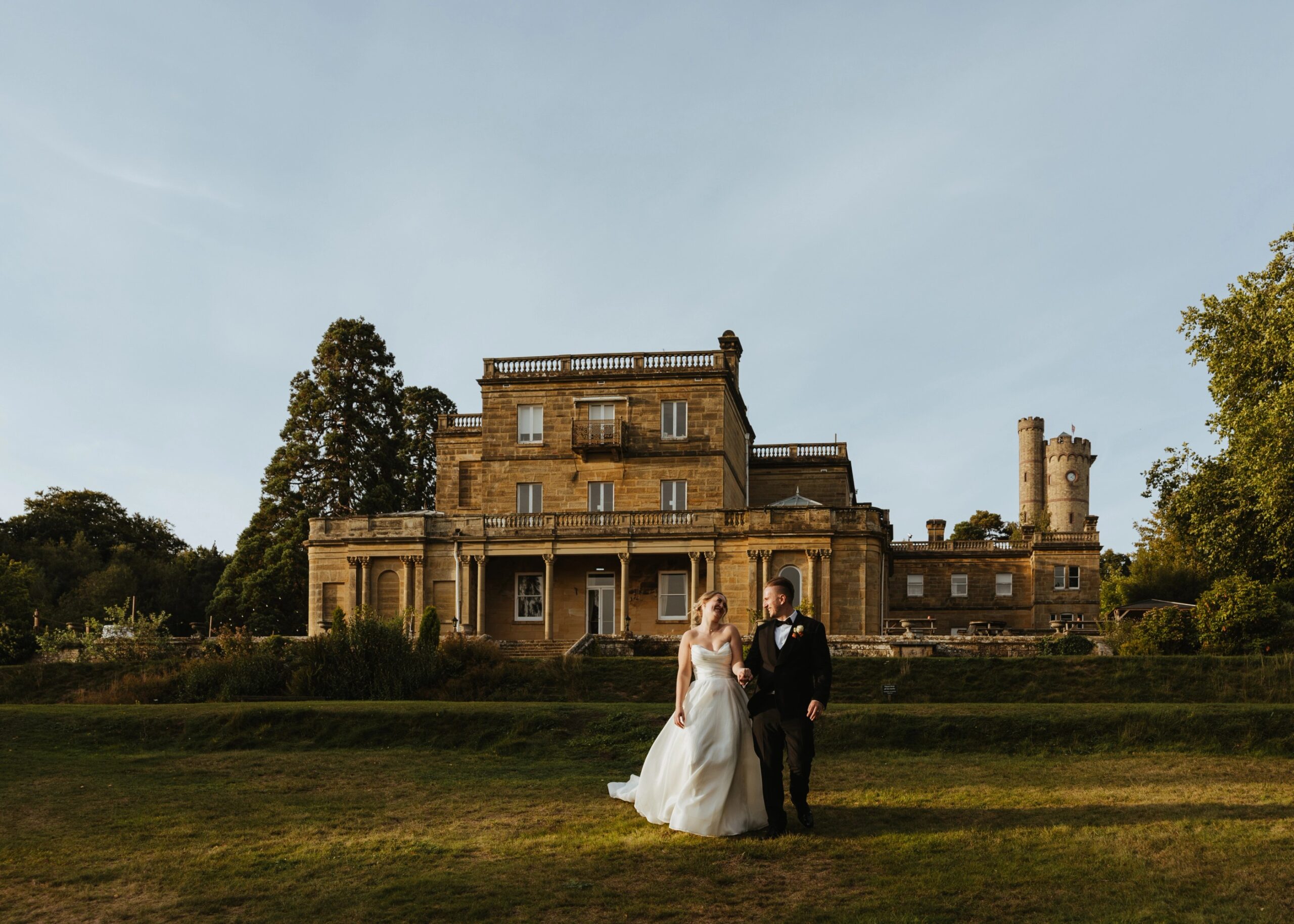 A couple on the lawn in front of the manor house, Salomons Estate