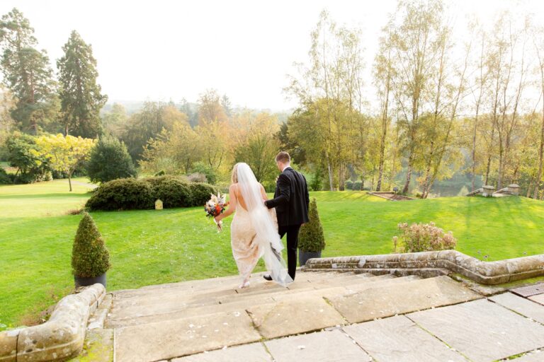 A couple walking across the terrace above the gardens, Salomons Estate