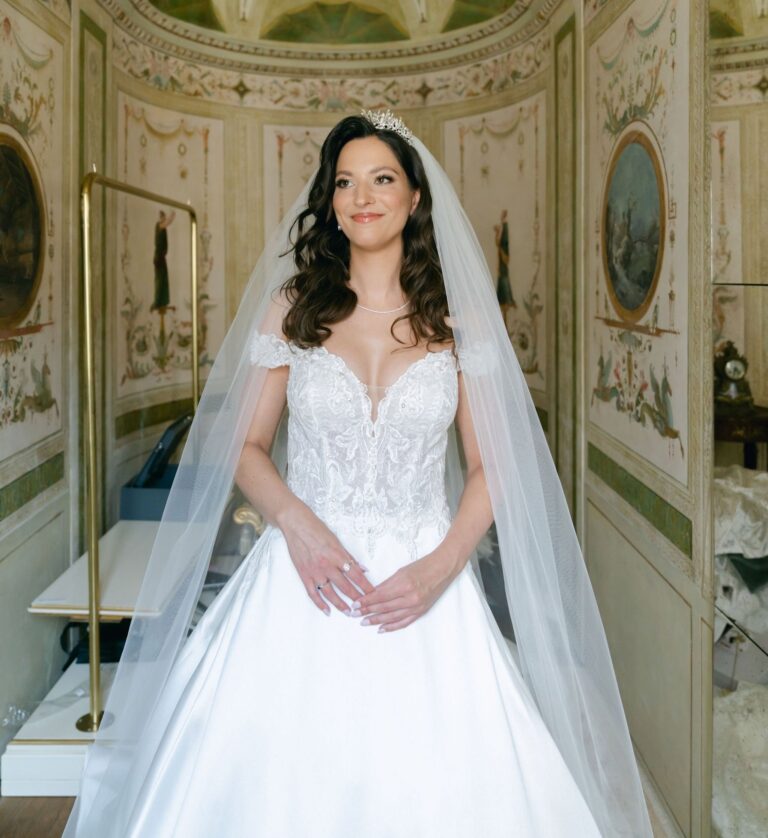 Bride in a veil and lace gown in a frescoed room, hair in a soft half-up style, Samantha Pretto