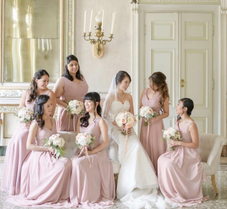 Bride and bridesmaids in blush gowns in a salon with chandeliers, Samantha Pretto