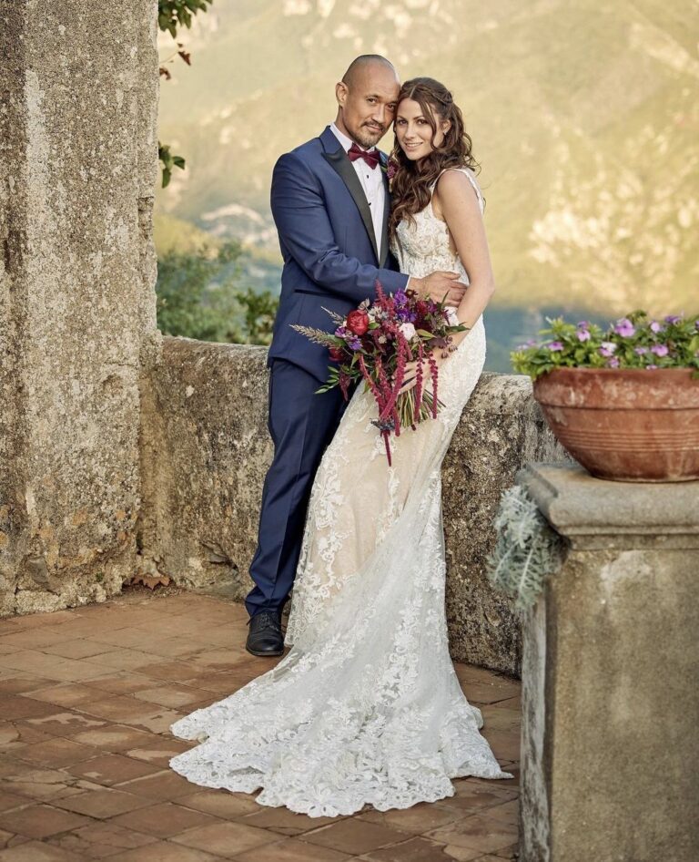 Couple on a stone terrace above the Amalfi hills, bridal bouquet and long waves, Samantha Pretto