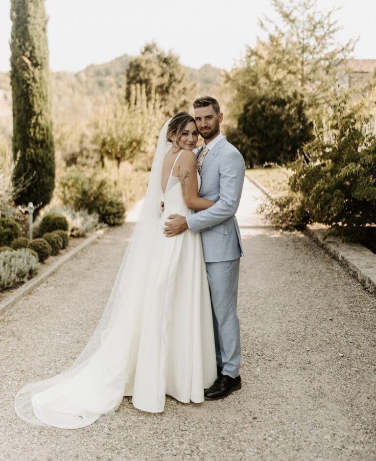 Couple on a gravel path between cypress trees, Samantha Pretto
