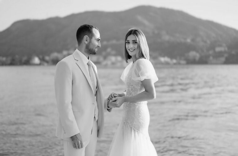 Couple holding hands on a lakeshore, black and white, Samantha Pretto