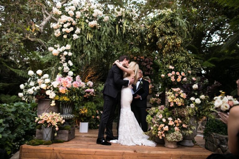 Couple kissing among tall arrangements of garden flowers, Samuel Lippke Studios