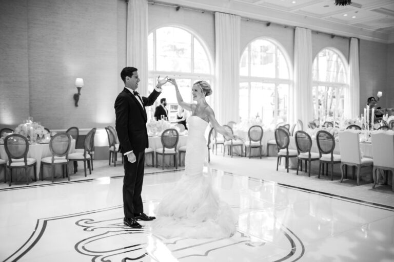 Black and white first dance beneath arched ballroom windows, Samuel Lippke Studios