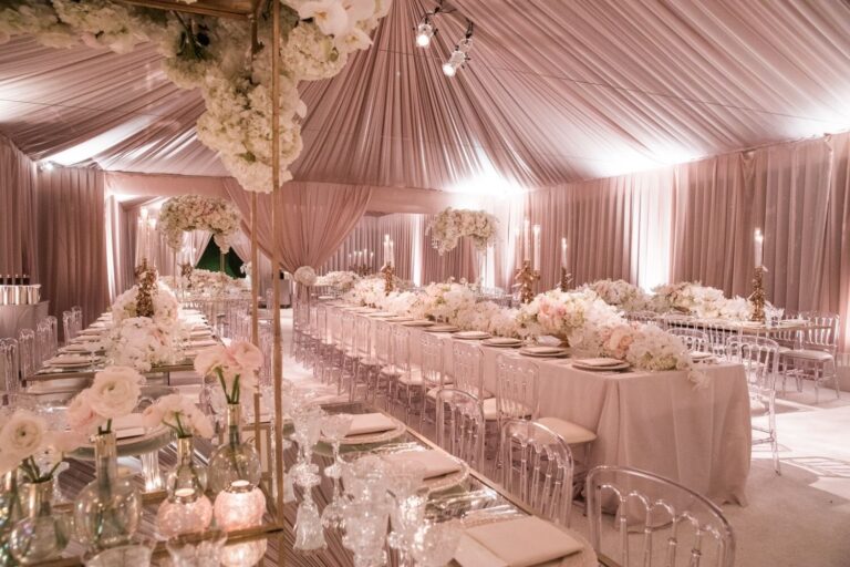 Tent draped in blush fabric above long reception tables, Samuel Lippke Studios