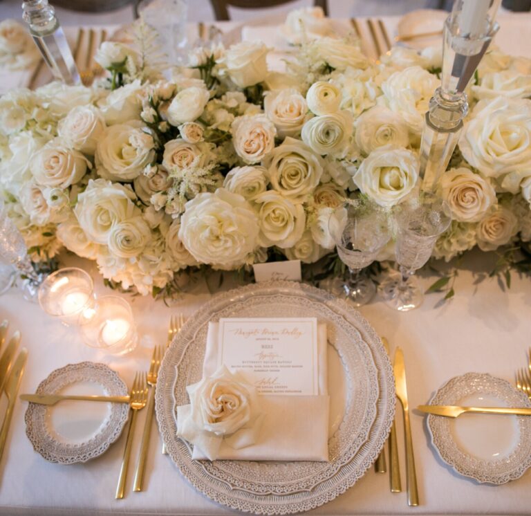 White roses and candlelight at a gold-rimmed place setting, Samuel Lippke Studios