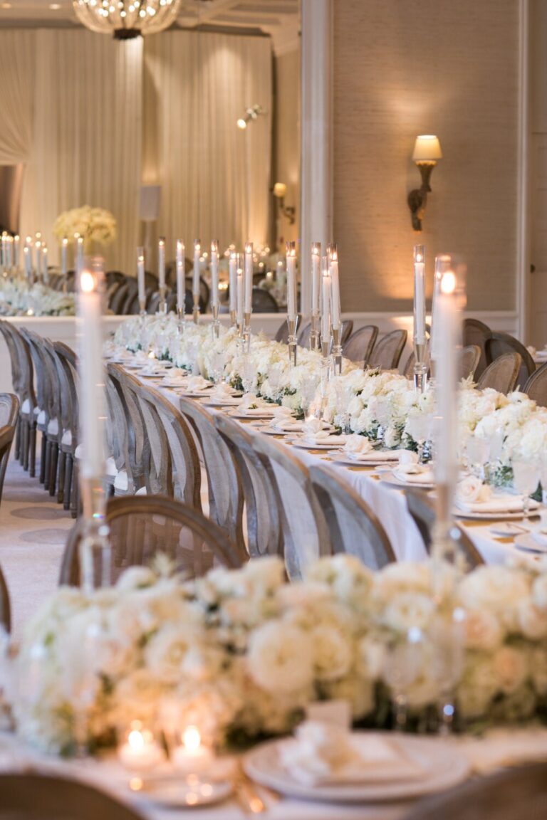 Candlelit table lined with low white flowers, Samuel Lippke Studios