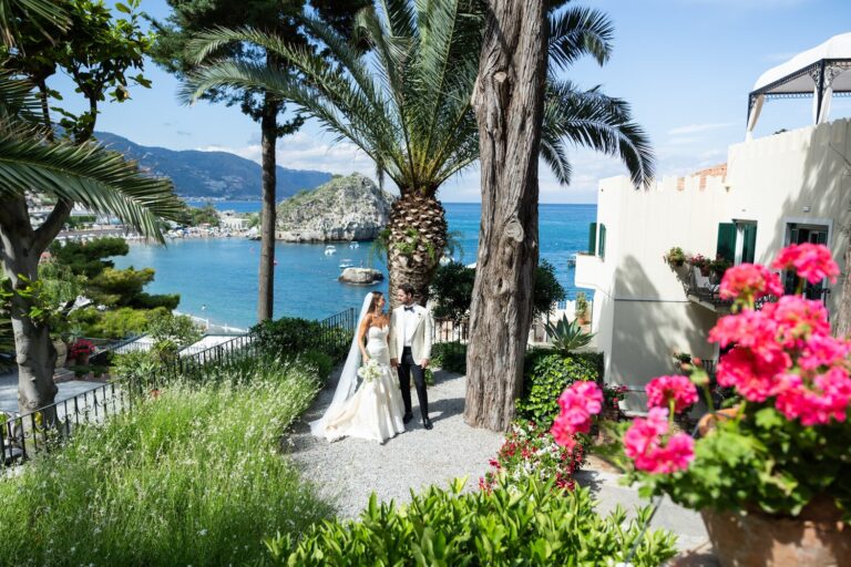 Bride beside a coastal garden of pink flowers with sea views, Samuel Lippke Studios