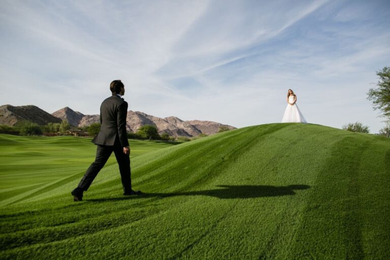 Groom walking a green hillside lawn toward the bride in the distance, Samuel Lippke Studios