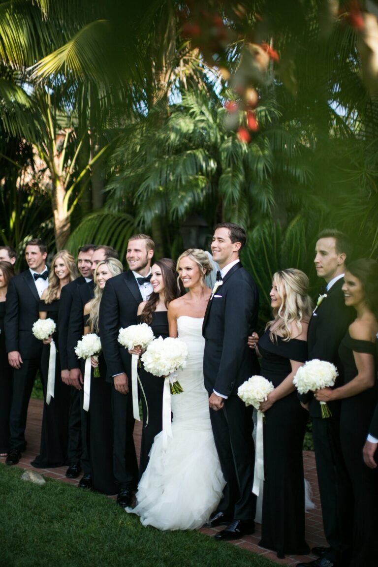 Wedding party standing together in a lush tropical garden, Samuel Lippke Studios