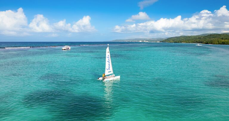 A sailing catamaran in the bay off the resort, Sandals Dunn's River