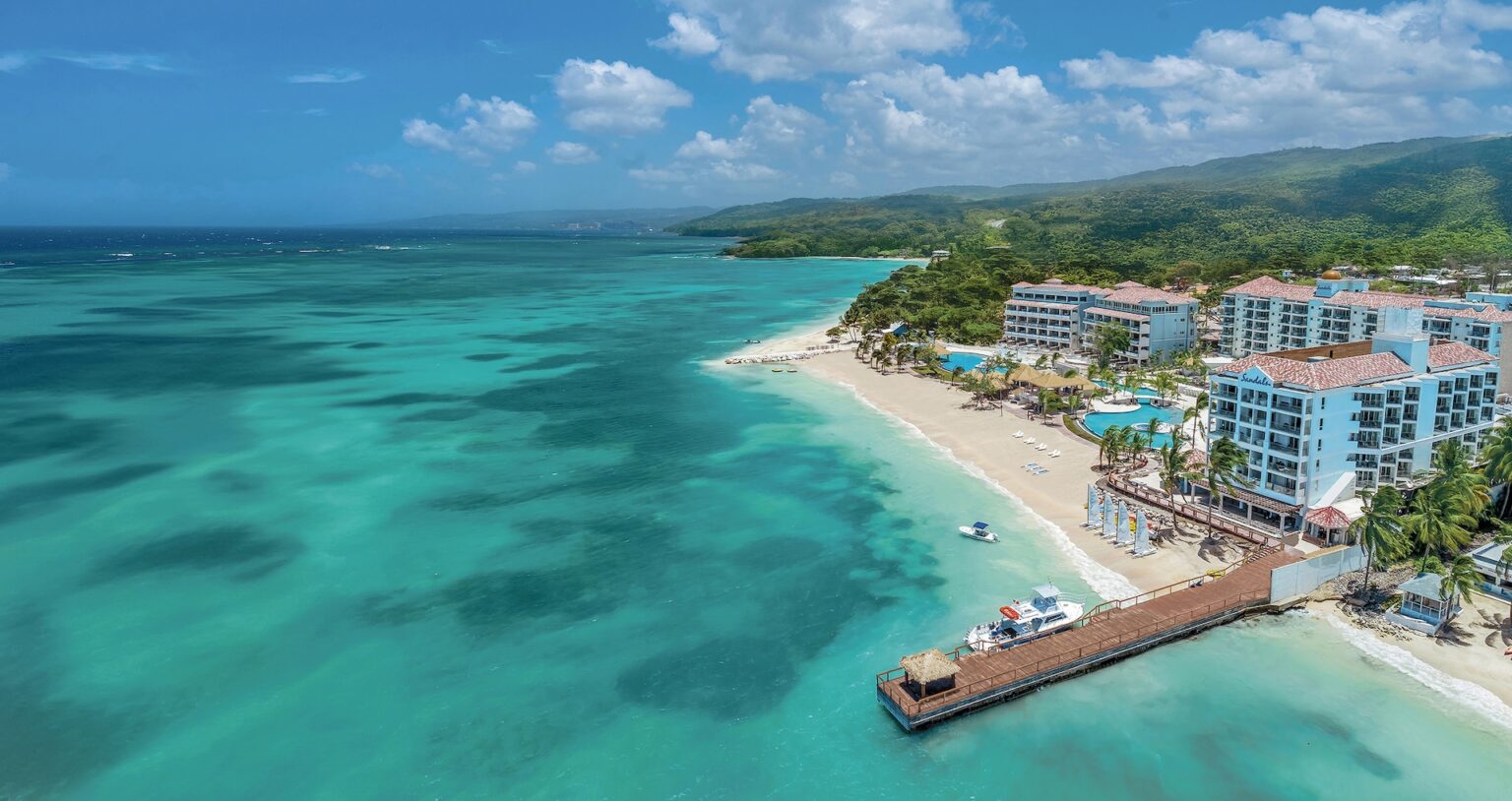 The resort buildings, the beach and the pier from above