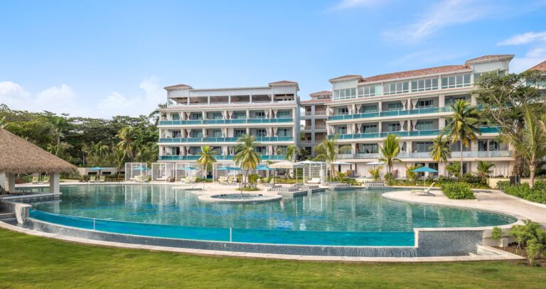 A resort building with balconies above the pool and lawn, Sandals Dunn's River