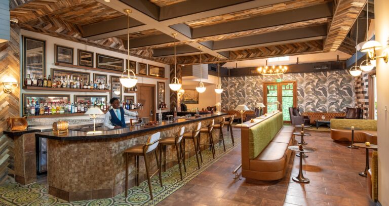 A bar with a timber ceiling and a bartender at work, Sandals Dunn's River