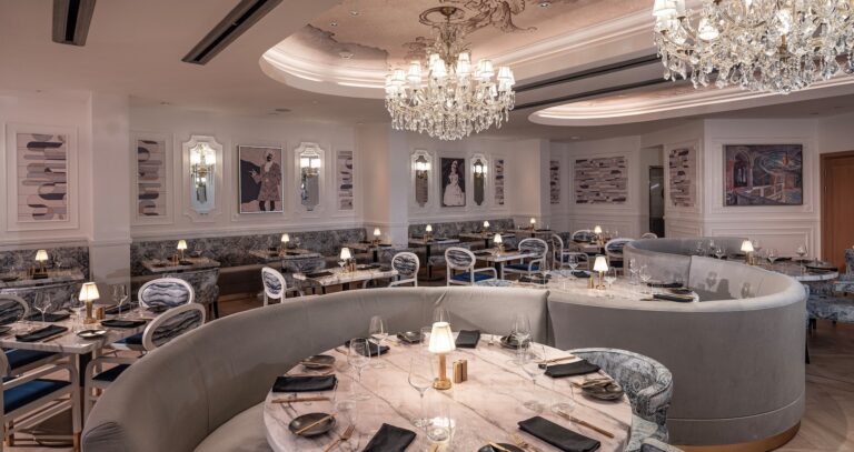 A formal dining room with chandeliers and banquette seating, Sandals Dunn's River