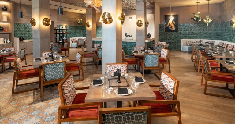 A restaurant with tiled walls and wooden tables, Sandals Dunn's River