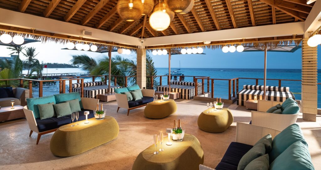 An open-air pavilion lounge with sofas facing the sea, Sandals Dunn's River